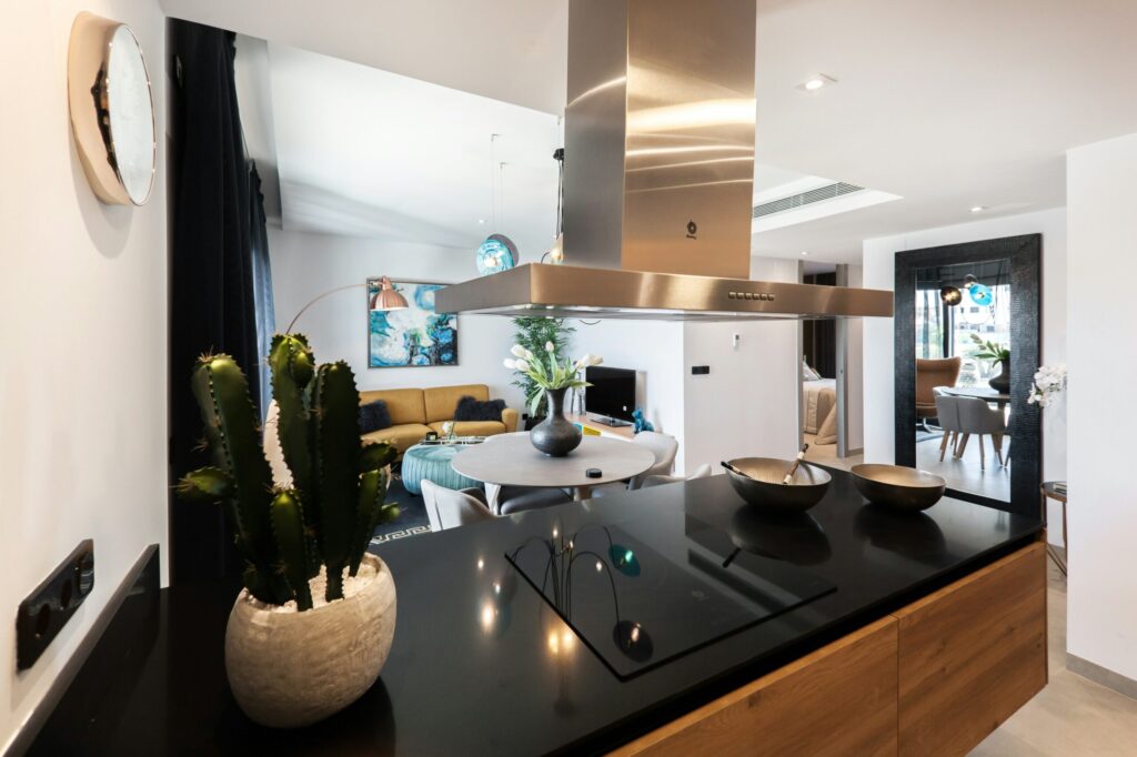 Modern Spanish apartment with an open kitchen, wood cabinetry and tiled flooring