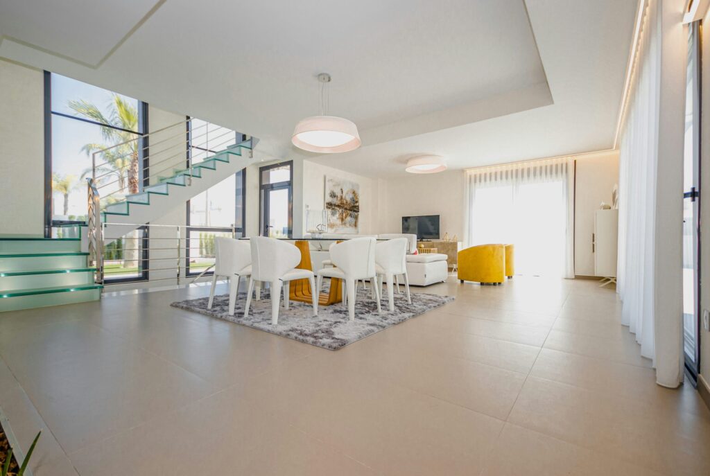 Bright contemporary Spanish living and dining room with tiled flooring